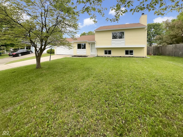 tri-level home featuring a chimney and driveway