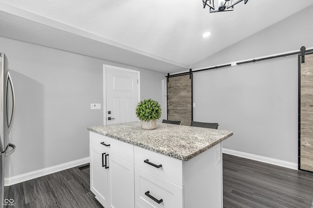 353 S Indiana St, Danville, IN 46122 - kitchen with a barn door, dark wood-type flooring, baseboards, a center island, and lofted ceiling