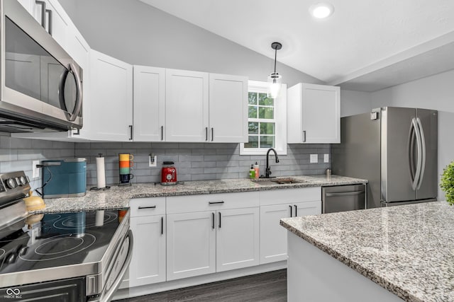 353 S Indiana St, Danville, IN 46122 - kitchen with stainless steel appliances, a sink, vaulted ceiling, tasteful backsplash, and white cabinetry