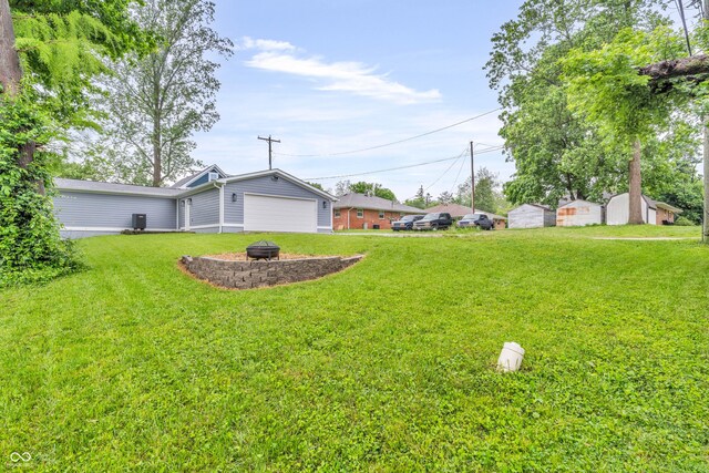 353 S Indiana St, Danville, IN 46122 - view of green lawn with an outdoor fire pit and a garage