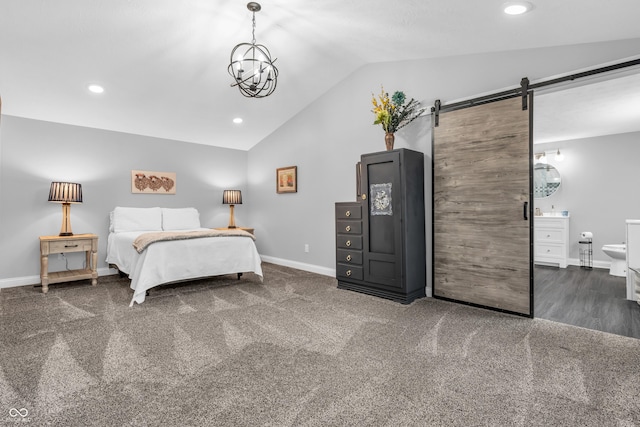 353 S Indiana St, Danville, IN 46122 - bedroom featuring a barn door, vaulted ceiling, baseboards, recessed lighting, and connected bathroom