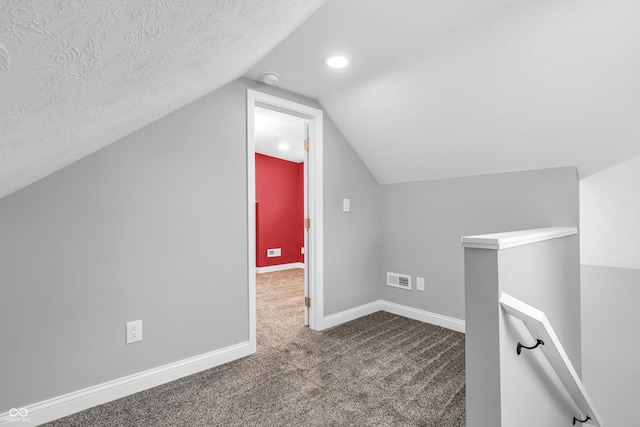 353 S Indiana St, Danville, IN 46122 - additional living space featuring dark carpet, vaulted ceiling, a textured ceiling, baseboards, and recessed lighting