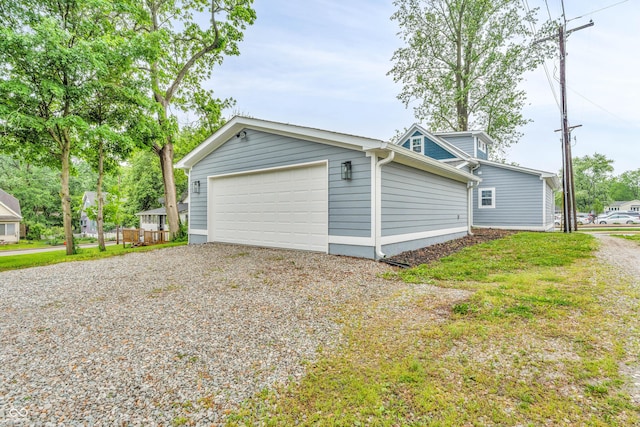 353 S Indiana St, Danville, IN 46122 - view of home's exterior featuring a garage and gravel driveway