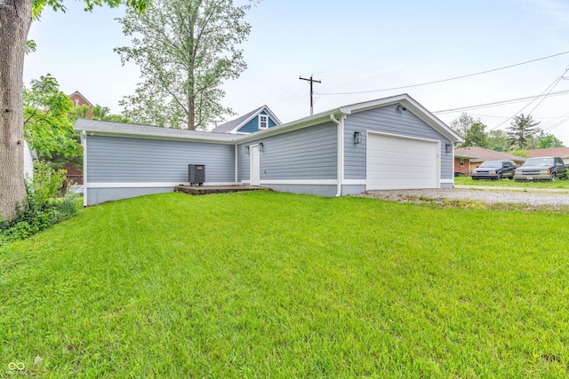 353 S Indiana St, Danville, IN 46122 - back of house featuring a lawn, gravel driveway, an attached garage, and central AC unit