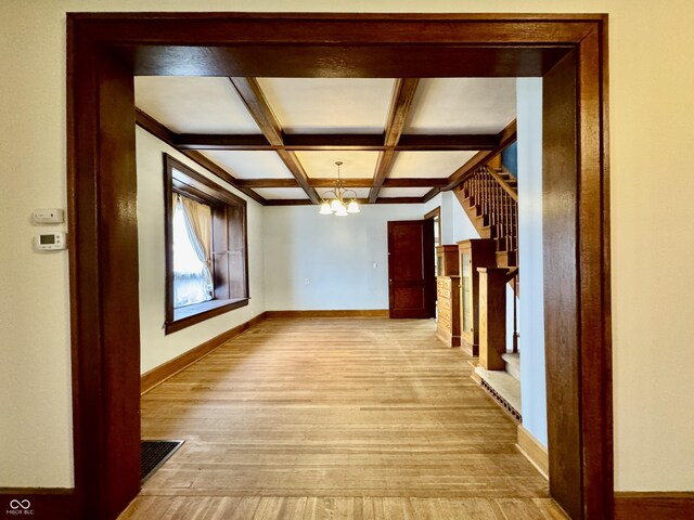 308 W Walnut St, Brownstown, IN 47220 - hallway with a chandelier, baseboards, light wood finished floors, beamed ceiling, and coffered ceiling