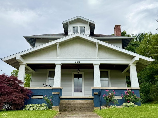 308 W Walnut St, Brownstown, IN 47220 - view of front of home with a porch and a chimney