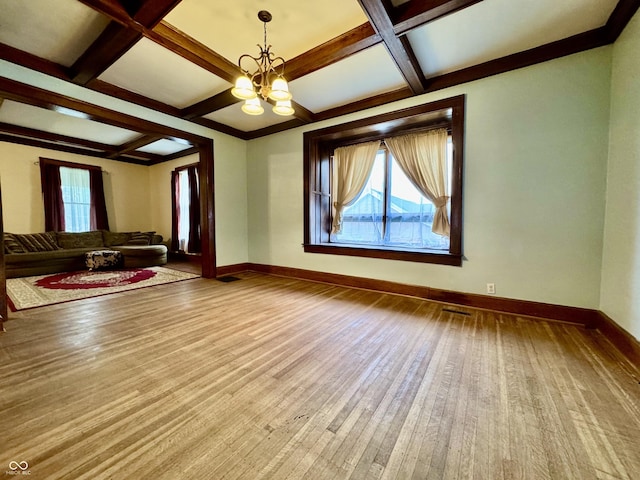 308 W Walnut St, Brownstown, IN 47220 - unfurnished living room featuring coffered ceiling, wood finished floors, a chandelier, baseboards, and beamed ceiling