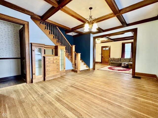 308 W Walnut St, Brownstown, IN 47220 - unfurnished living room with a chandelier, stairway, wood finished floors, coffered ceiling, and beamed ceiling