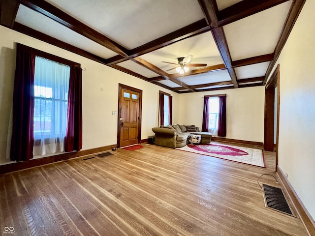 308 W Walnut St, Brownstown, IN 47220 - unfurnished living room featuring baseboards, wood finished floors, beam ceiling, a ceiling fan, and coffered ceiling