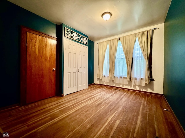 308 W Walnut St, Brownstown, IN 47220 - unfurnished bedroom featuring baseboards and wood finished floors