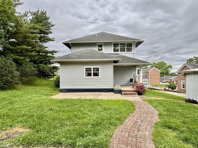308 W Walnut St, Brownstown, IN 47220 - rear view of property featuring a shingled roof, a yard, and a porch