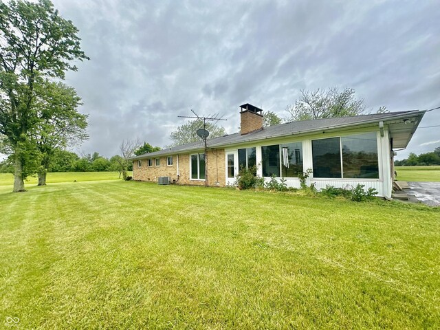 1154 W US Highway 136, Veedersburg, IN 47987 - back of property featuring a chimney, a yard, and cooling unit