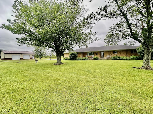 1154 W US Highway 136, Veedersburg, IN 47987 - view of front facade with a garage, a front yard, an outbuilding, and brick siding
