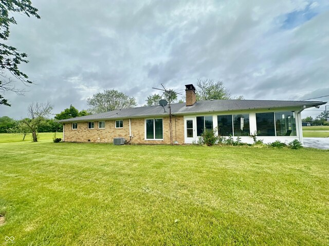 1154 W US Highway 136, Veedersburg, IN 47987 - back of house with a chimney, central AC, a yard, and brick siding