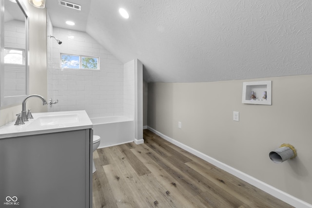 418 Harlan St, Indianapolis, IN 46201 - bathroom featuring vaulted ceiling, baseboards, wood finished floors, toilet, and vanity