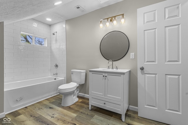 418 Harlan St, Indianapolis, IN 46201 - bathroom with toilet, wood finished floors, a textured ceiling, vanity, and baseboards