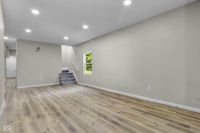 418 Harlan St, Indianapolis, IN 46201 - unfurnished living room with stairs, recessed lighting, baseboards, and light wood-style floors