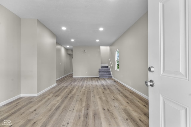 418 Harlan St, Indianapolis, IN 46201 - unfurnished living room featuring light wood-style floors, baseboards, stairway, and recessed lighting