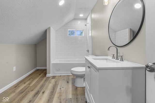 418 Harlan St, Indianapolis, IN 46201 - bathroom with vaulted ceiling, wood finished floors, a textured ceiling, toilet, and baseboards
