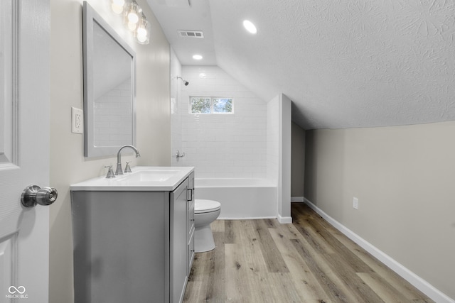 418 Harlan St, Indianapolis, IN 46201 - bathroom featuring vaulted ceiling, wood finished floors, vanity, a textured ceiling, and baseboards