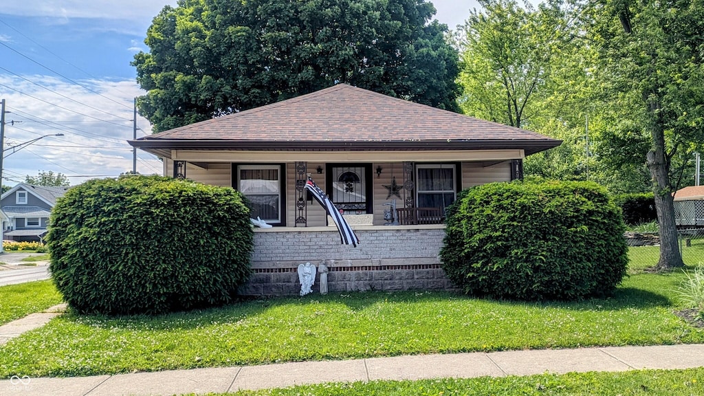 100 N 6th Ave, Beech Grove, IN 46107 - bungalow-style house with roof with shingles, a front yard, and covered porch