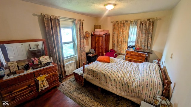 100 N 6th Ave, Beech Grove, IN 46107 - bedroom with dark wood-style flooring and a textured ceiling