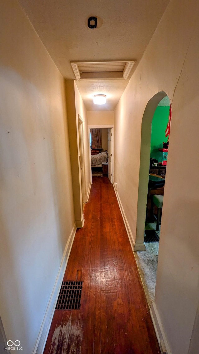 100 N 6th Ave, Beech Grove, IN 46107 - hallway featuring arched walkways, wood-type flooring, attic access, and baseboards