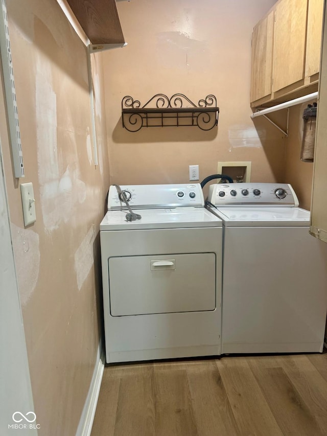 2931 Byrkit St, Indianapolis, IN 46217 - laundry room with cabinet space, washer and clothes dryer, and light wood-style flooring