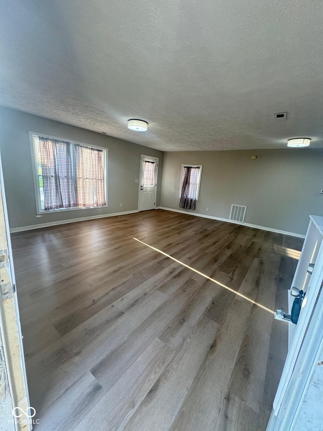 2931 Byrkit St, Indianapolis, IN 46217 - unfurnished living room with wood finished floors and a textured ceiling