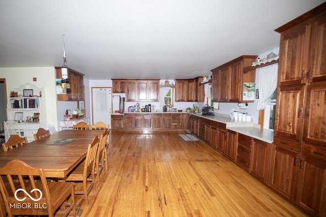 6190 E County Road 800 N, North Vernon, IN 47265 - kitchen featuring light countertops, fridge, light wood finished floors, and brown cabinets
