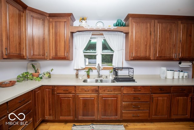 6190 E County Road 800 N, North Vernon, IN 47265 - kitchen featuring a sink, light countertops, brown cabinets, and light wood-style floors