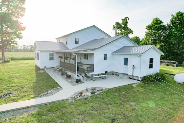 6190 E County Road 800 N, North Vernon, IN 47265 - back of house with a porch, a yard, metal roof, and a patio area