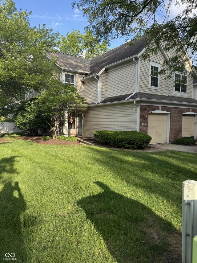 9535 Longwell Dr, Indianapolis, IN 46240 - view of front of property featuring a garage, a front yard, driveway, and brick siding