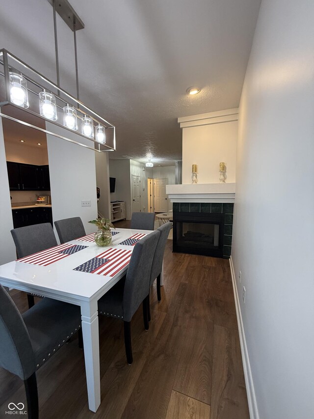 9535 Longwell Dr, Indianapolis, IN 46240 - dining area with wood finished floors, a fireplace, and baseboards