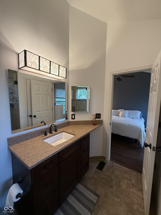 9535 Longwell Dr, Indianapolis, IN 46240 - bathroom featuring vanity, a towering ceiling, ensuite bathroom, and baseboards