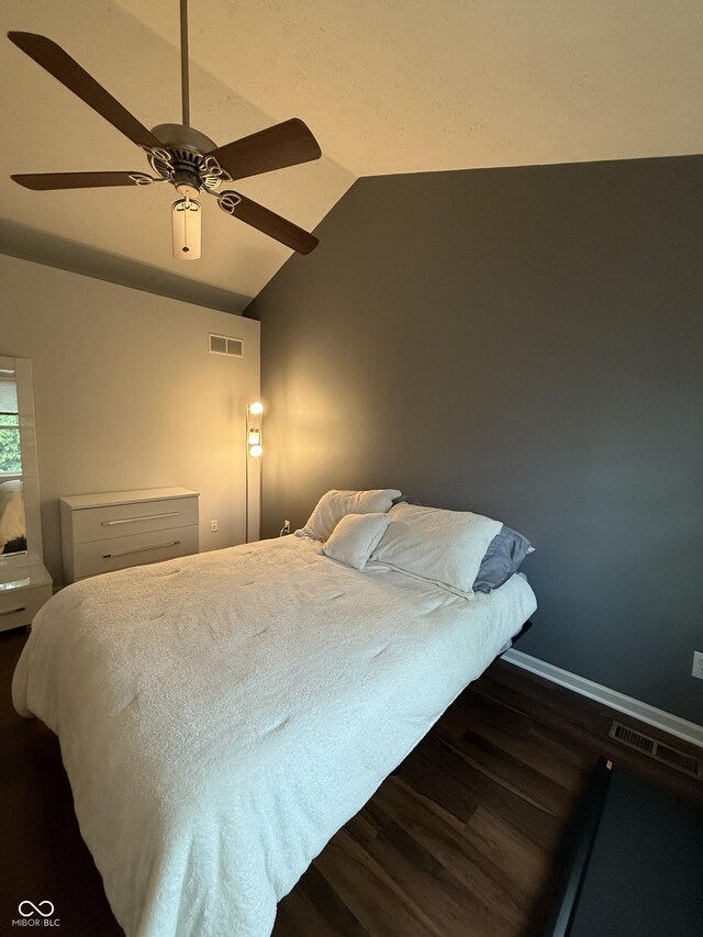 9535 Longwell Dr, Indianapolis, IN 46240 - bedroom featuring dark wood-style flooring, vaulted ceiling, and ceiling fan