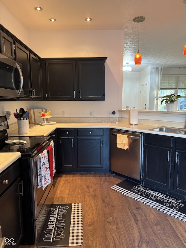 9535 Longwell Dr, Indianapolis, IN 46240 - kitchen with appliances with stainless steel finishes, light wood-type flooring, dark cabinetry, and recessed lighting
