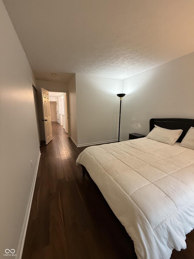 9535 Longwell Dr, Indianapolis, IN 46240 - bedroom featuring dark wood finished floors and baseboards