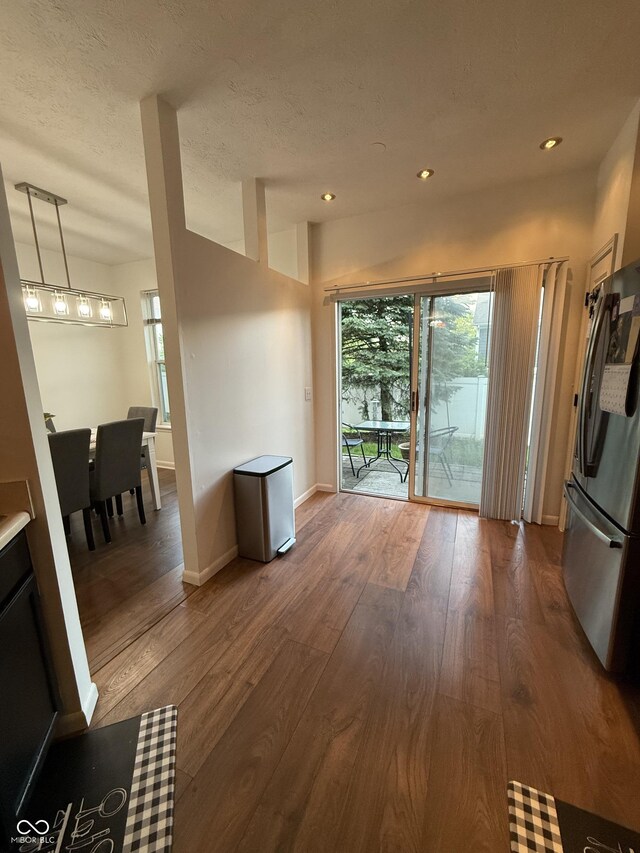 9535 Longwell Dr, Indianapolis, IN 46240 - living room with wood finished floors, healthy amount of natural light, baseboards, recessed lighting, and a textured ceiling