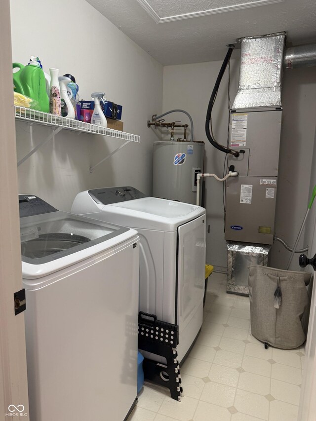 9535 Longwell Dr, Indianapolis, IN 46240 - laundry room featuring electric water heater, washer and clothes dryer, and light flooring