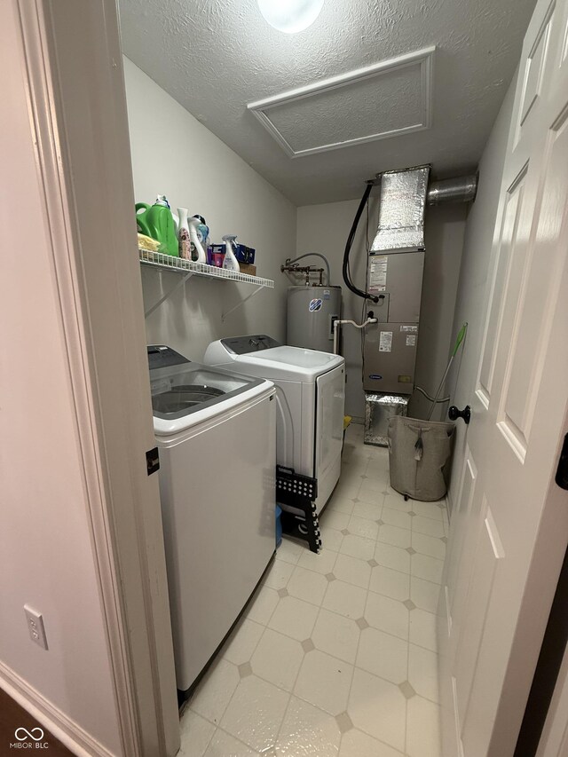 9535 Longwell Dr, Indianapolis, IN 46240 - laundry area featuring attic access, water heater, washing machine and dryer, a textured ceiling, and heating unit
