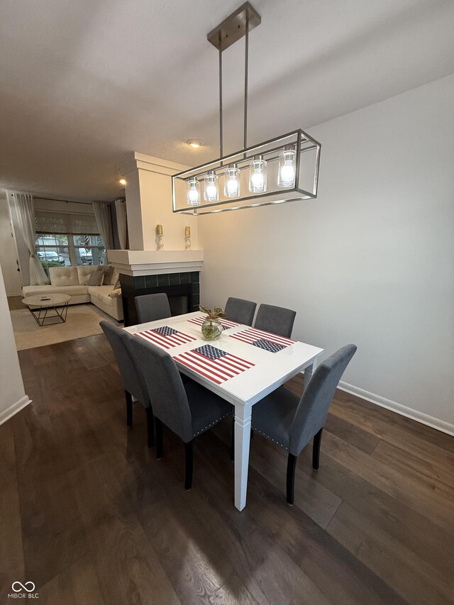 9535 Longwell Dr, Indianapolis, IN 46240 - dining room with dark wood finished floors, baseboards, and a fireplace