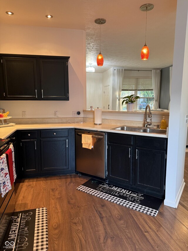 9535 Longwell Dr, Indianapolis, IN 46240 - kitchen with dishwasher, a sink, dark cabinets, wood finished floors, and pendant lighting