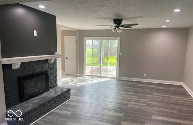 7731 Scarborough Blvd S, Indianapolis, IN 46256 - unfurnished living room with baseboards, a ceiling fan, wood finished floors, recessed lighting, and a brick fireplace