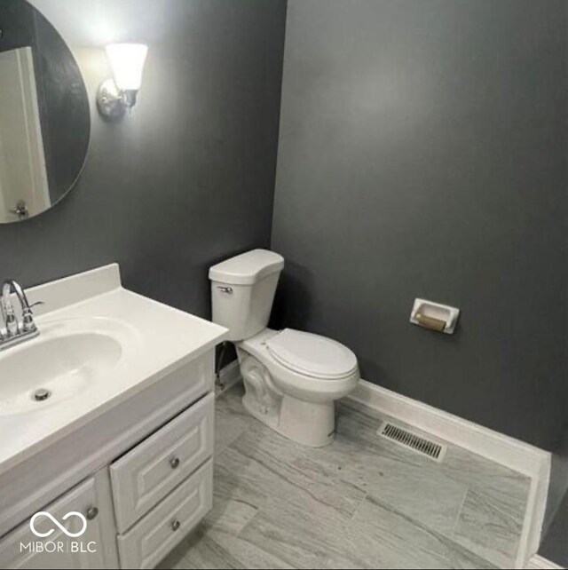 7731 Scarborough Blvd S, Indianapolis, IN 46256 - bathroom featuring toilet, vanity, and baseboards