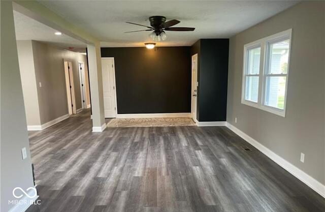 7731 Scarborough Blvd S, Indianapolis, IN 46256 - spare room with dark wood-style flooring, a ceiling fan, and baseboards