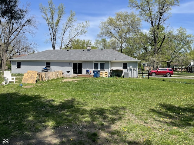 7731 Scarborough Blvd S, Indianapolis, IN 46256 - back of property featuring a lawn, a chimney, and roof with shingles