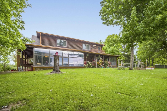 10484 N County Road 750 W, Freetown, IN 47235 - back of property with a sunroom and a lawn
