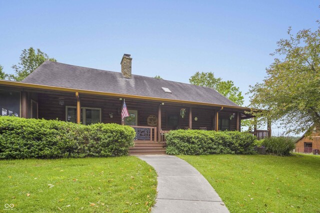 10484 N County Road 750 W, Freetown, IN 47235 - back of house featuring a porch, a yard, and a chimney