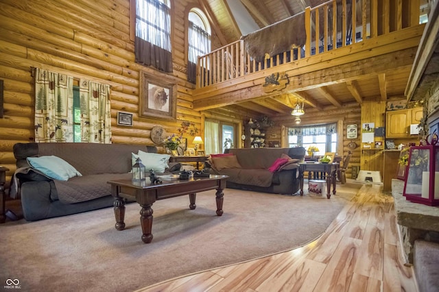10484 N County Road 750 W, Freetown, IN 47235 - living area with light wood-style floors, log walls, a towering ceiling, and wood ceiling with exposed beams